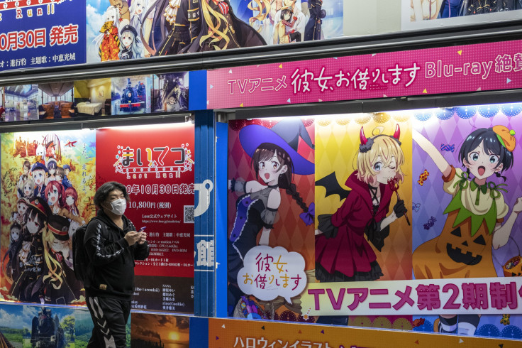 A man wearing a face mask walks past a manga advert on November 13, 2020 in Tokyo, Japan.