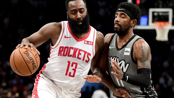 James Harden #13 of the Houston Rockets is defended by Kyrie Irving #11 of the Brooklyn Nets 