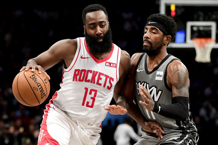 James Harden #13 of the Houston Rockets is defended by Kyrie Irving #11 of the Brooklyn Nets 