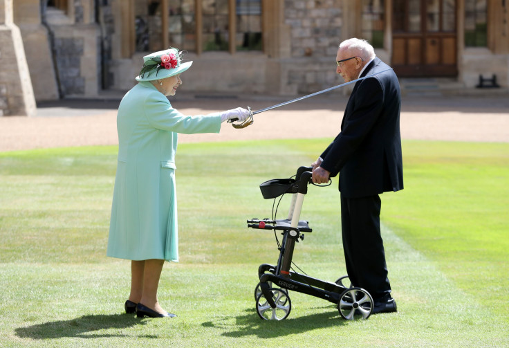 Queen Elizabeth II awards Captain Sir Thomas Moore with the insignia of Knight Bachelor at Windsor Castle on July 17, 2020 in Windsor, England. 