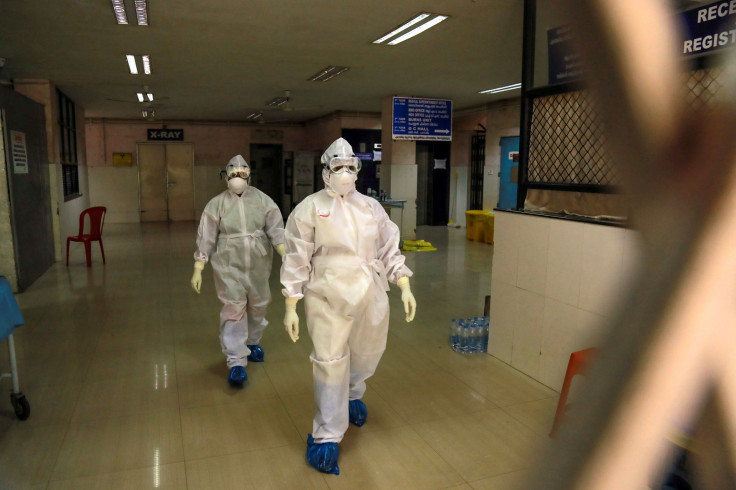 Health officials in full protective gear