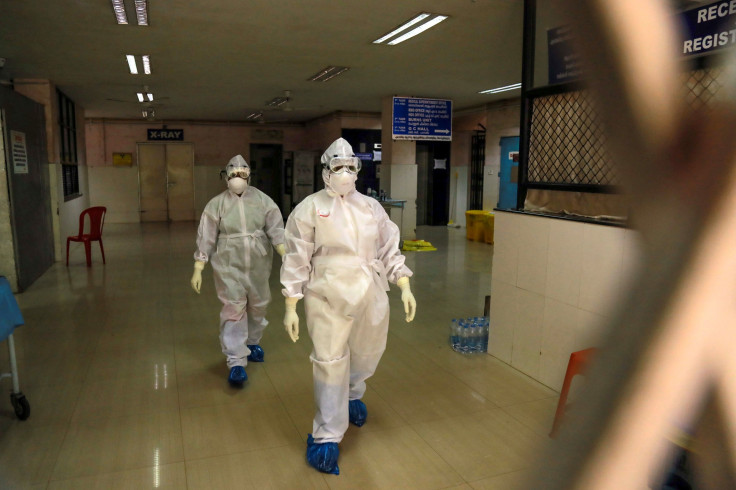 Health officials in full protective gear 