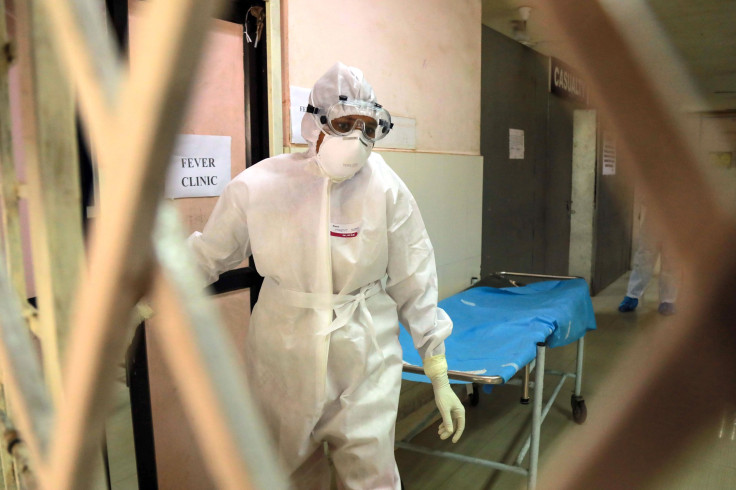 Health officials in full protective gear walk inside an isolation ward of Ernakulam Medical College in Kochi