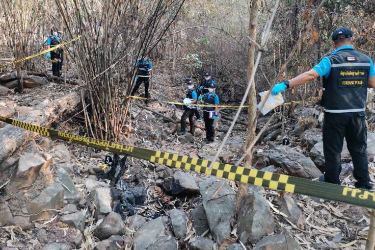 Forensic police at the scene in a rubber plantation where the burned remains, believed to be of a missing 19-year-old woman, were found on Tuesday morning, in Wang Thong district, Phitsanulok.