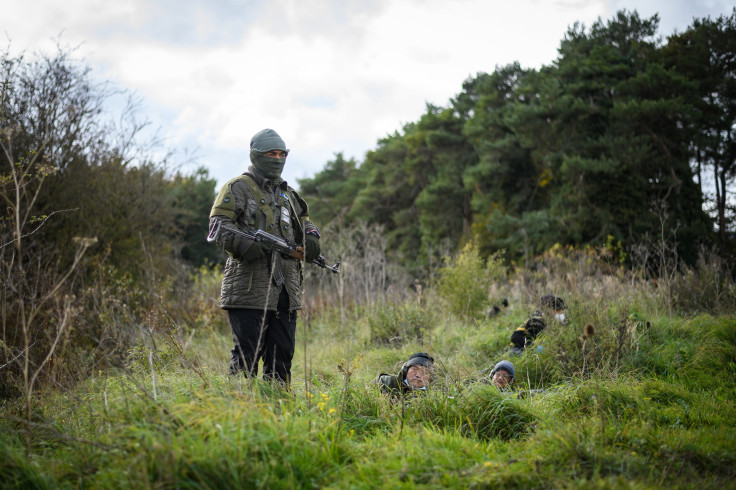 Role-play actors prepare to take part in an ambush during a Mission Rehearsal Exercise ahead of the UK Task Group deployment to Mali, on the Ministry of Defence training area on Salisbury Plain