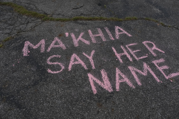Supporters write messages in chalk at a vigil in Columbus, Ohio on April 21, 2021 in memory of MaKhia Bryant, 16, who was shot and killed by a Columbus Police Department officer. 