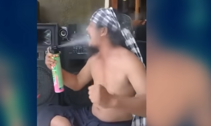 Bali Man Ki Galang Pamungkas spraying insecticide in his mouth