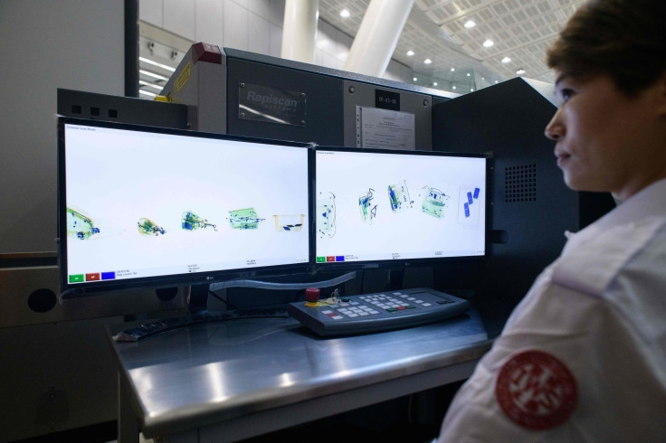 Luggage X-ray machines are demonstrated by event staff during a media tour inside the West Kowloon station of the High Speed Rail Link train to Guangzhou in Hong Kong