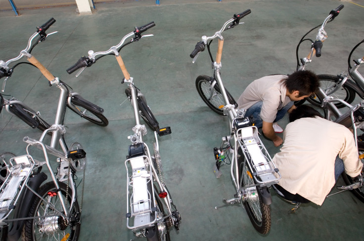 Workers work on electric bicycles in Repow electric vehicles factory on September 17, 2007 in Jinhua, Zhejiang province, China.