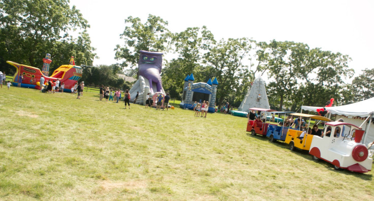 Children's rides and bouncy casltes at the East Hampton Library Children's Fair at Gardiner's Farm