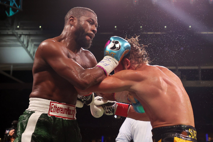 Floyd Mayweather exchanges blows with Logan Paul (yellow shorts) during their contracted exhibition boxing match at Hard Rock Stadium on June 06, 2021 in Miami Gardens, Florida.