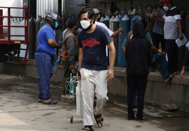 Residents gather to refill their oxygen tanks