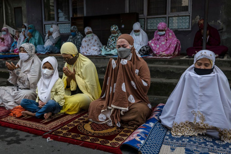 Indonesian Muslims pray as they perform Eid Al-Adha