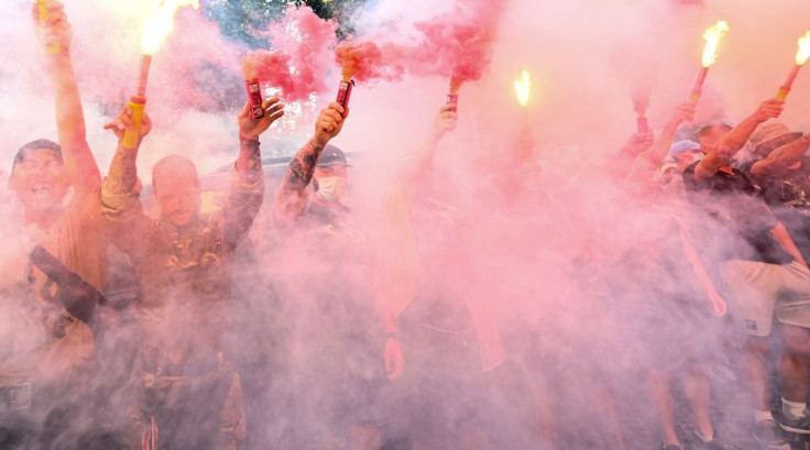 Activists burn flares in memory of Vitaly Shishov