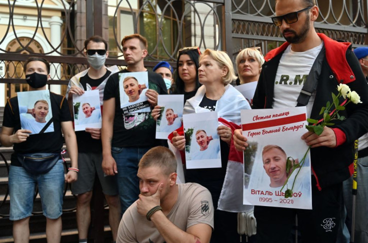Activists hold a picture of Vitaly Shishov