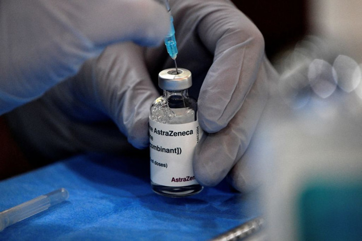 A paramedic prepares a dose of AstraZeneca vaccine