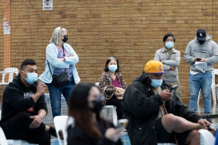 People wait or the AstraZeneca vaccine