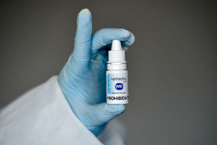 A health worker shows a bottle of Ivermectin