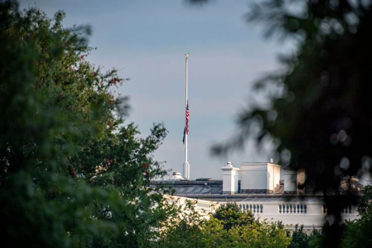 The US flag flies at half mast over the White House