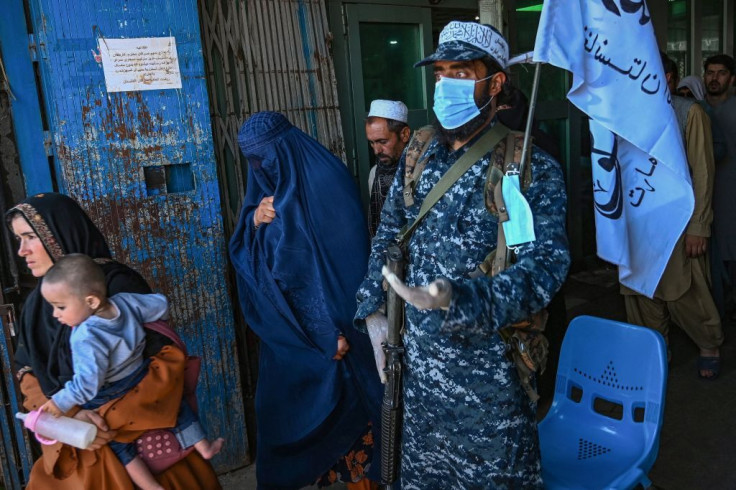 A Taliban fighter stands guard