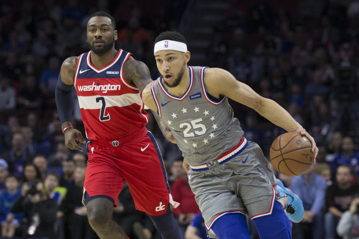 Ben Simmons #25 of the Philadelphia 76ers dribbles the ball against John Wall #2 of the Washington Wizards 