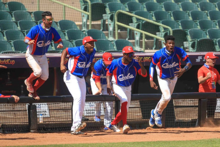 Players of the Cuba run out of the dugout to celebrate victory after the game