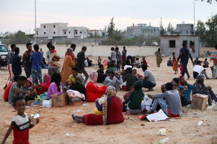 African migrants gather at a makeshift shelter in the capital Tripoli's suburb of Ain Zara