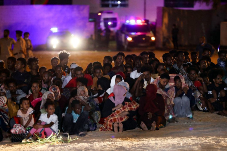 African migrants gather at a makeshift shelter in the capital Tripoli's suburb of Ain Zara