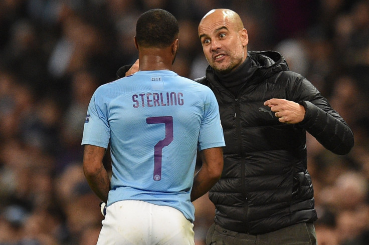 Manchester City's Spanish manager Pep Guardiola (R) talks with Manchester City's English midfielder Raheem Sterling