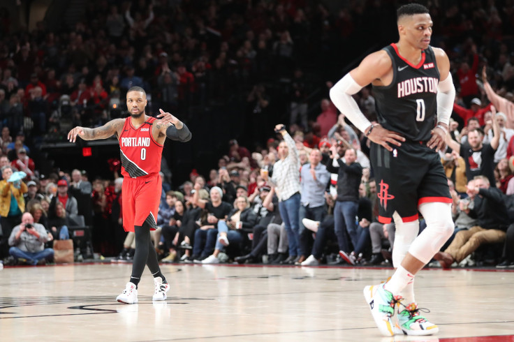Damian Lillard #0 of the Portland Trail Blazers hypes up the crowd alongside Russell Westbrook #0 of the Houston Rockets
