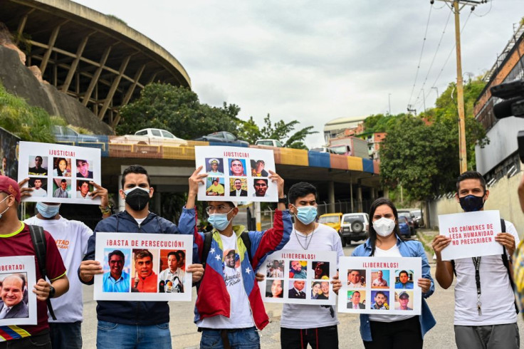 Relatives of political prisoners carry signs with pictures of them calling the attention of the Prosecutor of the ICC 