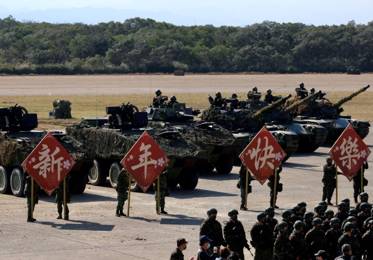 Taiwans army troops display the Happy New Year signs for photographs after a drill in Hsinchu military base ahead of the Chinese New Year holiday on January 19, 2021.
