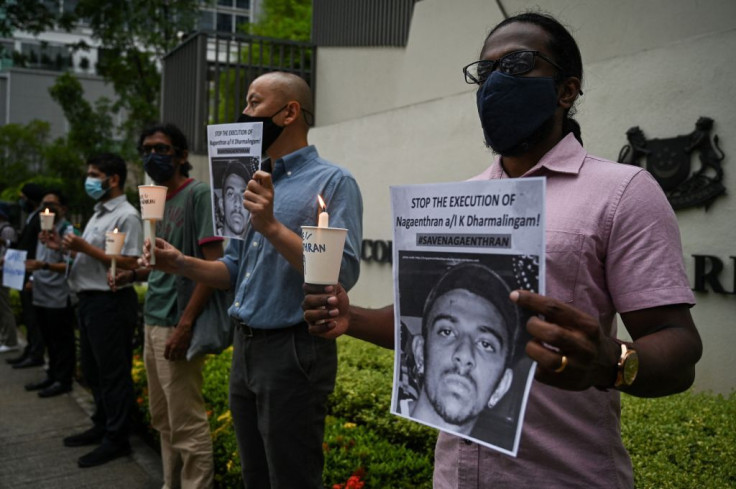 Activists holding placards attend a candlelight vigil against the impending execution of Nagaenthran K. Dharmalingam