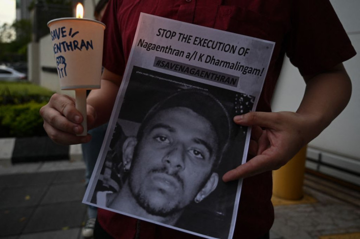 An activist holding a placard attends a candlelight vigil against the impending execution of Nagaenthran K. Dharmalingam