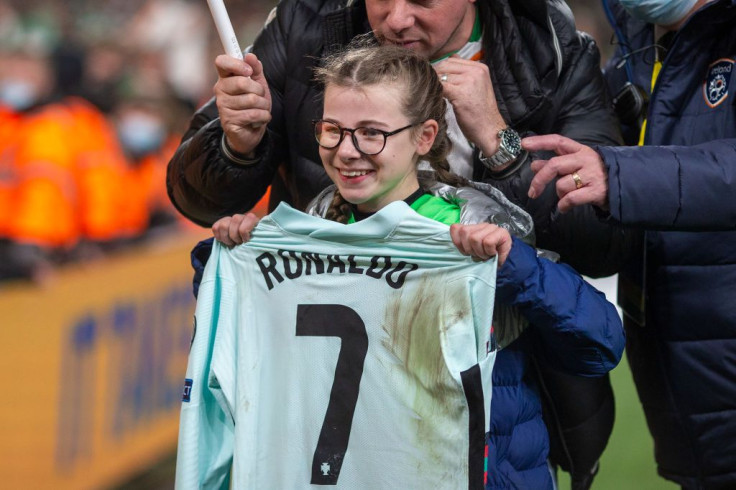 Young fan Addison Whelan, 11, who invaded the pitch at full time, poses for photographs with the shirt of Cristiano Ronaldo #7