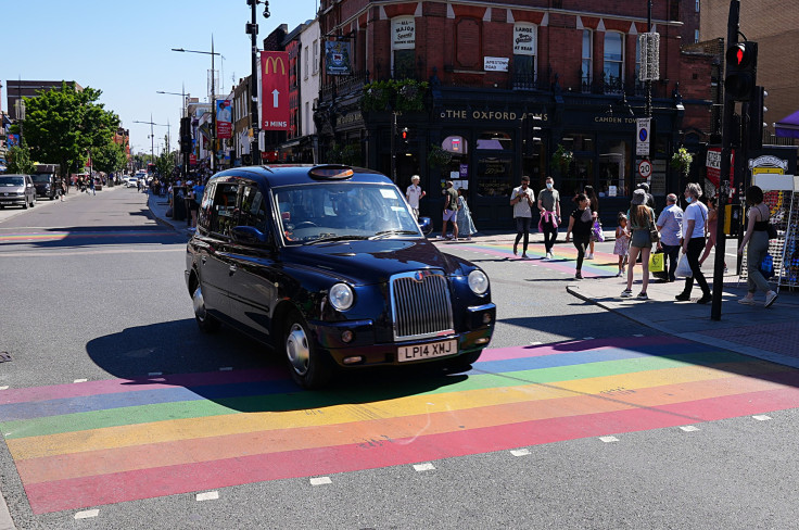 A black cab travels over a rainbow crossing in Camden during UK Pride Month 2021 