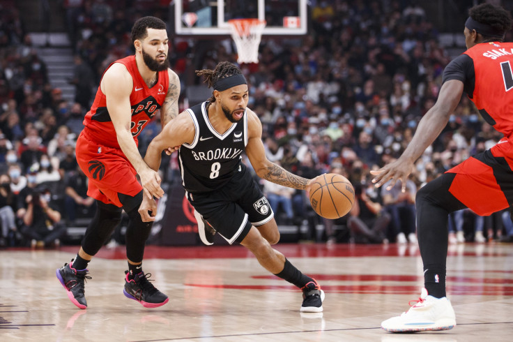 Patty Mills #8 of the Brooklyn Nets drives on Fred VanVleet #23 of the Toronto Raptors 