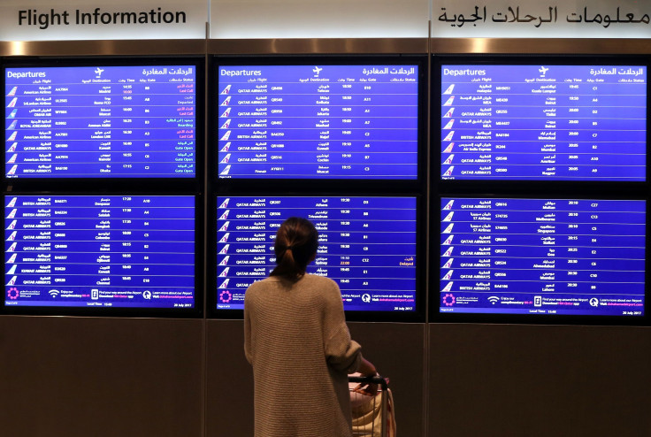 A passenger checks the departures board at the Hamad International Airport in Doha on July 20, 2017.