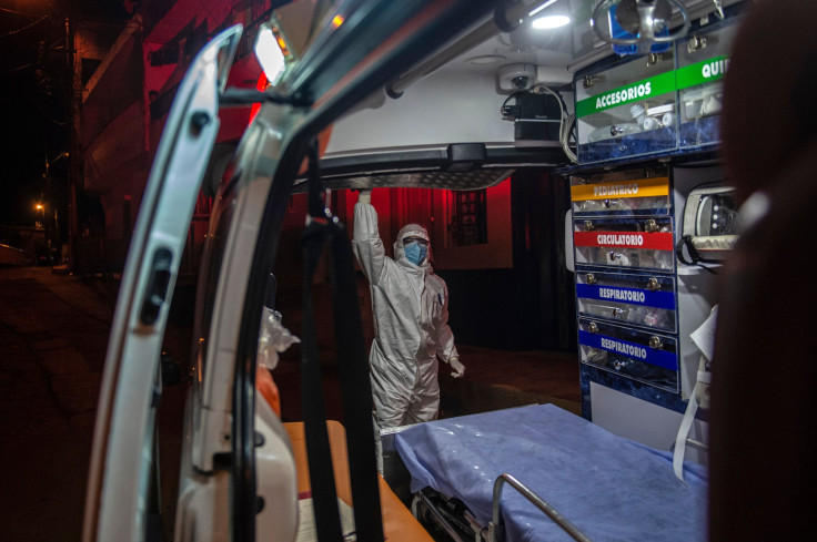 A paramedic closes an ambulance after assisting a patient