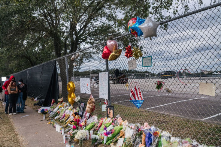 People look at a memorial to those who died at the Astroworld festival 