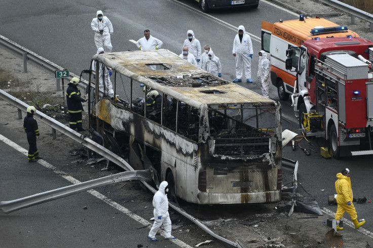 Officials work at the site of a bus accident, in which at least 46 people were killed