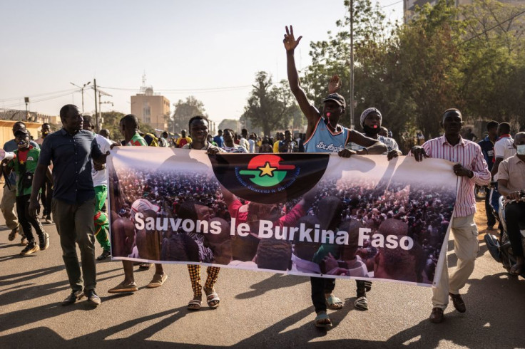 Protestors hold a banner reading 'Save the Burkina Faso' during a demonstration in Ouagadougou