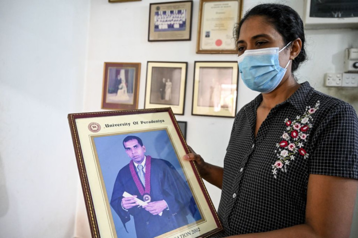 Nilushi Dissanayake the wife of Sri Lankan factory manager holds her husband's graduation photograph