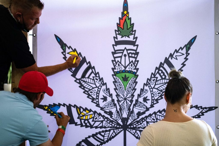Attendees color in a cannabis leaf at the Cannabis Expo 2021 in Sandton