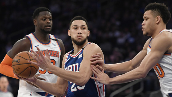 Ben Simmons #25 of the Philadelphia 76ers dribbles the ball against Julius Randle #30 and Kevin Knox II #20 of the New York Knicks
