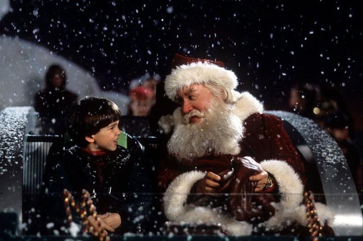 Tim Allen on a sled talking with a child in a scene from the film 'The Santa Clause', 1994.