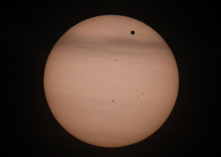 Planet Venus (R-black spot) transits in front of the Sun