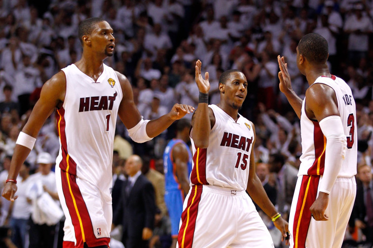 Chris Bosh #1, Mario Chalmers #15 and Dwyane Wade #3 of the Miami Heat 