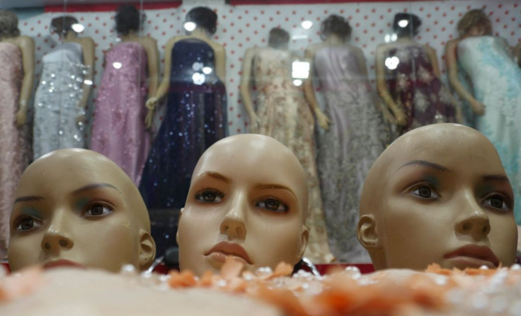 The heads of mannequins are seen at a at a women's clothing store in Herat