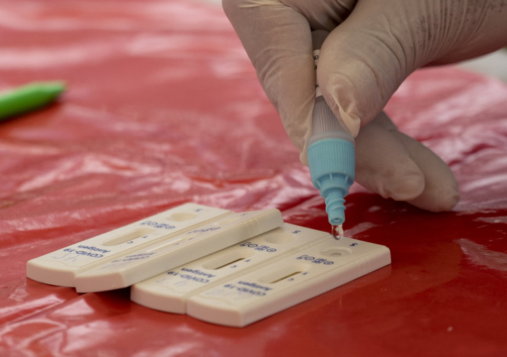 A lab technician manipulates Covid-19 PCR tests at a free mobile testing facility set by Limas municipality in the populous district of La Victoria